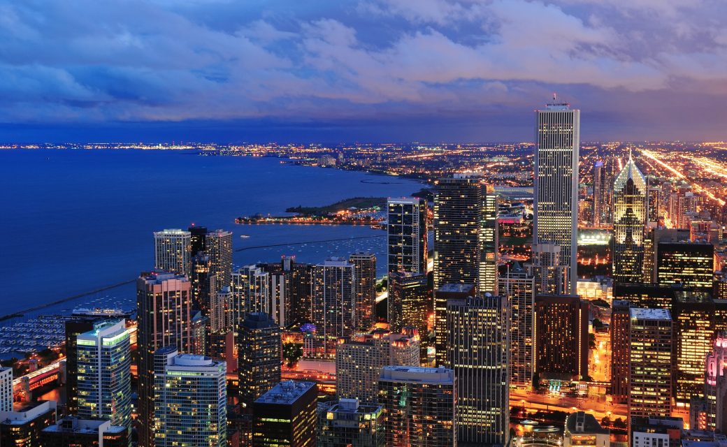 Chicago skyline panorama aerial view with skyscrapers over Lake Michigan with cloudy  sky at dusk.