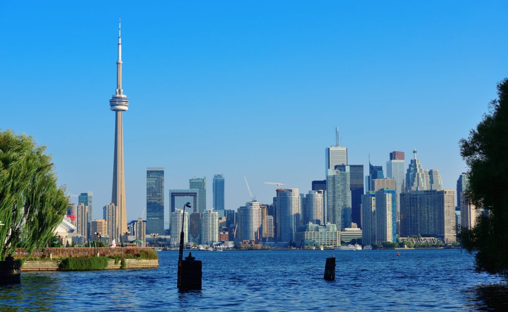 Toronto skyline in the day over lake with urban architecture viewed from park